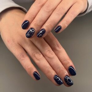 Deep navy blue winter gel nails with subtle nail art at La Suite Corbridge